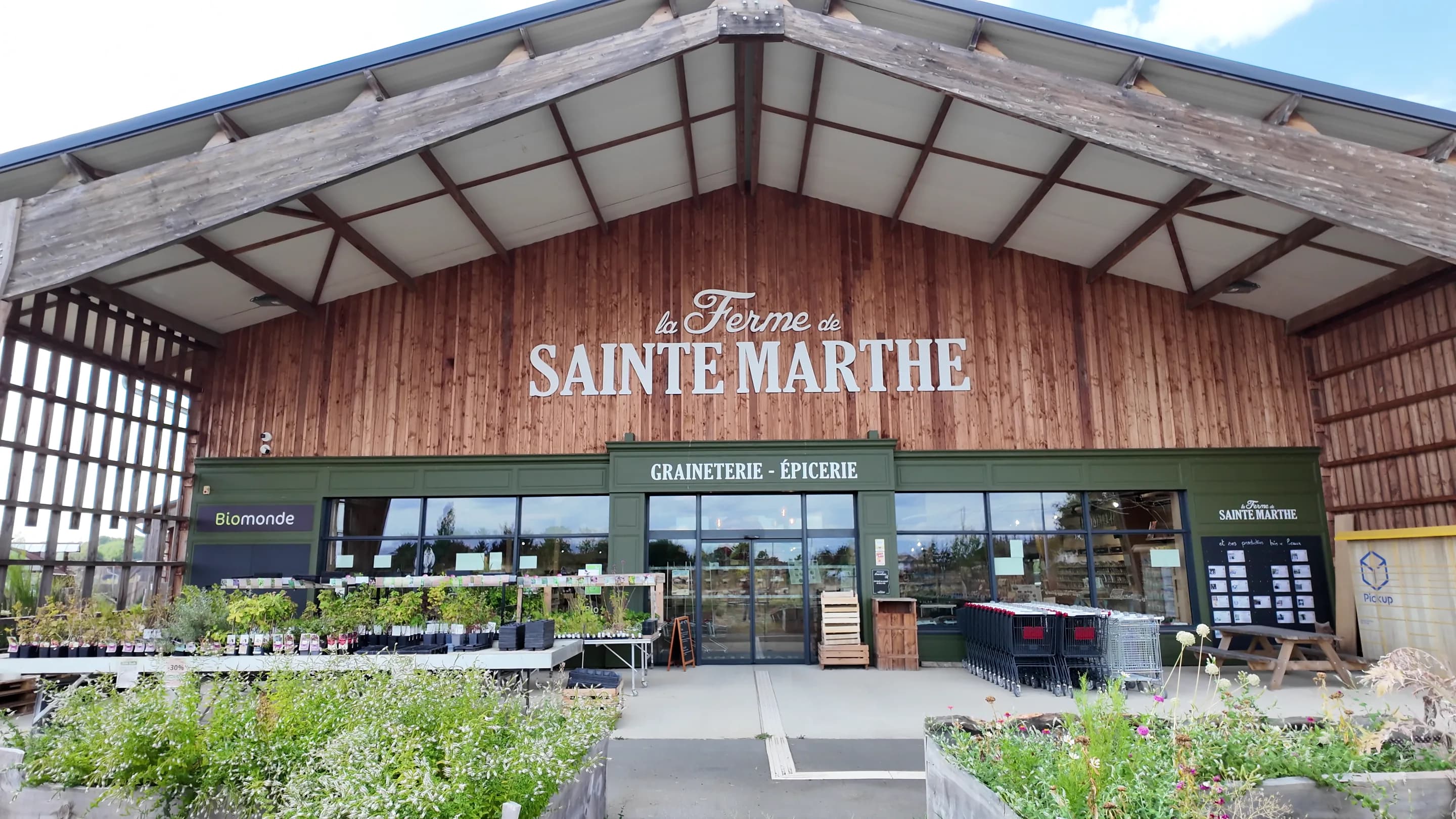 The entrance to the La Ferme de Sainte-Marthe seed shop, with the company name above the door